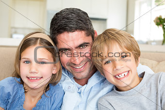 Father and children smiling at home