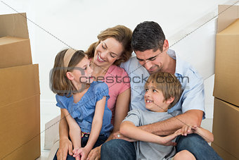 Happy family sitting in new house