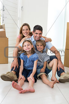 Family sitting on floor in new house