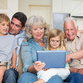 Smiling family using digital tablet