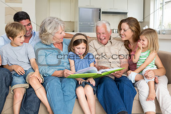 Family reading storybook in living room