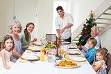 Family having Christmas meal at dining table