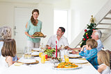 Mother serving Christmas meal to family