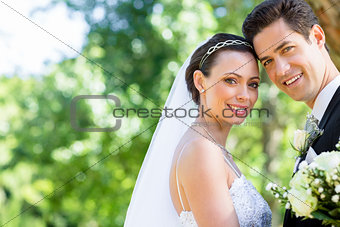 Loving bride and groom in garden