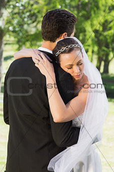 Bride embracing groom on wedding day