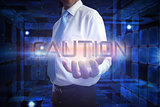Businessman presenting the word caution
