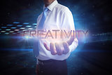 Businessman presenting the word creativity