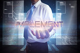Businessman presenting the word implement