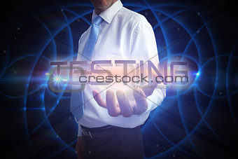 Businessman presenting the word testing