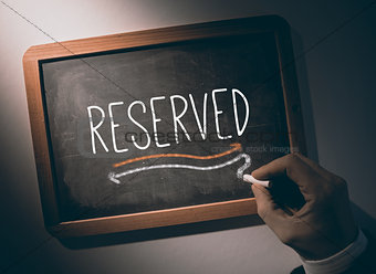 Hand writing Reserved on chalkboard