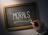 Hand writing Morals on chalkboard