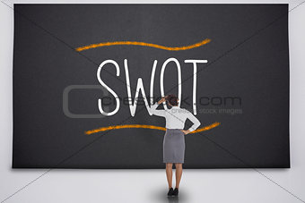Businesswoman considering the word swot