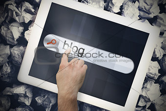 Hand touching blog on search bar on tablet screen