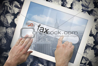 Hand touching fax on search bar on tablet screen