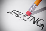 Pencil erasing the word Stalking