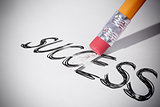 Pencil erasing the word Success