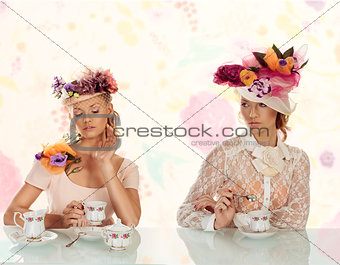 two blonds girl with flowers hat