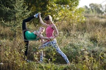 Two beautiful gymnasts or dancers working out