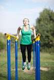 Woman gymnast exercising on parallel bars