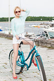 beautiful girl with city bike at sea pier