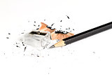 Pencil with sharpening shavings on white background