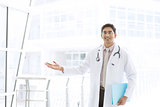 Asian Indian male medical doctor showing welcome hand sign