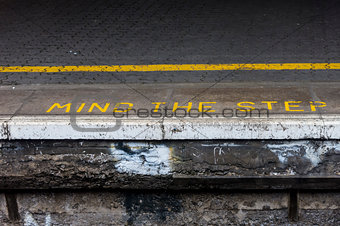 Mind the step warning on railway platform
