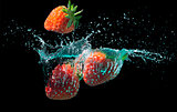 Strawberries splashed into water