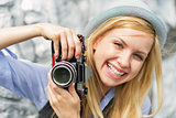 Portrait of smiling young hipster with retro photo camera