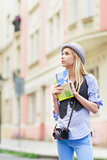Young woman tourist with map in the city