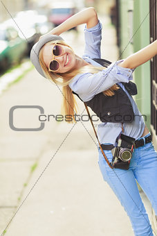 Portrait of young hipster in the city having fun