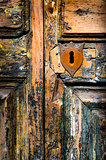 Vintage key hole on weathered wooden door