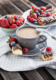 Cup of coffee and chocolate eclairs