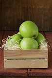 Granny Smith green apples in a wooden box