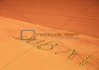 Dubaiu written on sand on beach