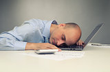 Businessman sleeping on a laptop