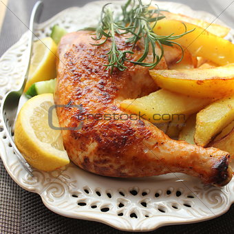 roasted chicken leg with  potato and lemon