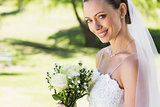 Closeup of bride with bouquet in garden