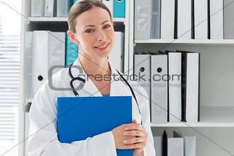 Portrait of female doctor holding folder