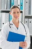 Beautiful female doctor holding folder