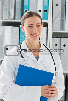 Beautiful female doctor holding folder