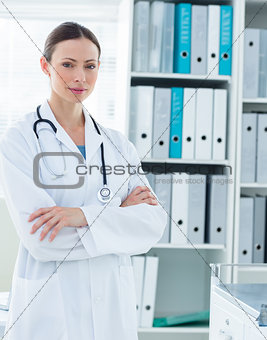 Confident doctor standing arms crossed