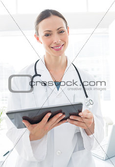 beautiful doctor holding digital tablet