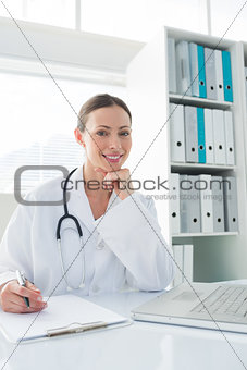 Doctor sitting at desk in clinic