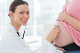 Portrait of doctor checking pregnant woman