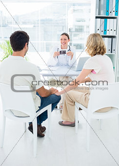 Expectant couple consulting gynaecologist