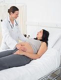 Female doctor talking with pregnant woman