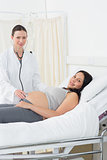 Confident doctor examining pregnant woman