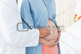 Doctor checking expectant woman