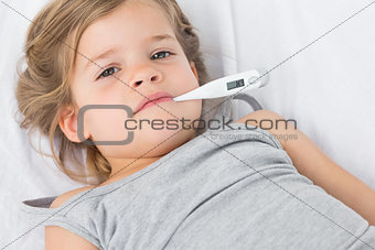 Sick girl with thermometer in mouth